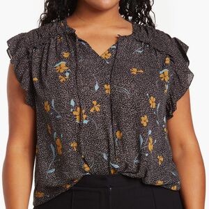 Women’s sleeveless DR2 blouse 1x. Black with floral print and ruffle detail.